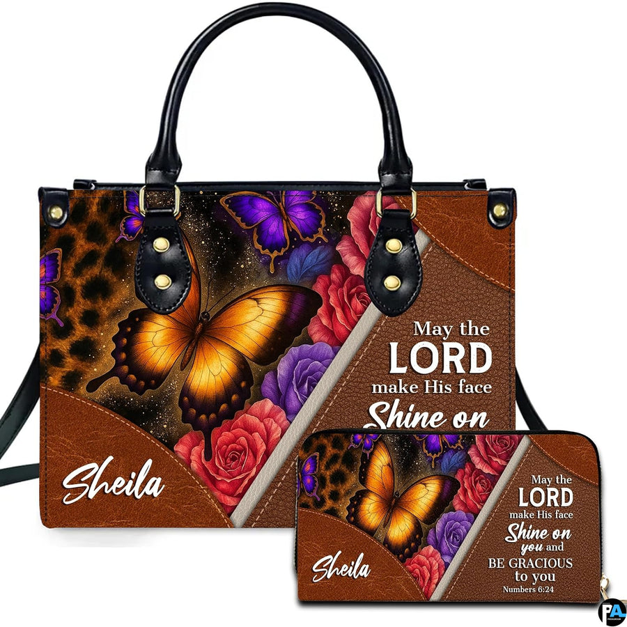 Front view of leopard print and amber butterfly handbag and matching wallet with blooming roses and diagonal trim.