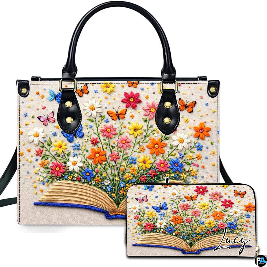 Open book and butterfly floral embroidery artwork displayed across accessory set on white background.