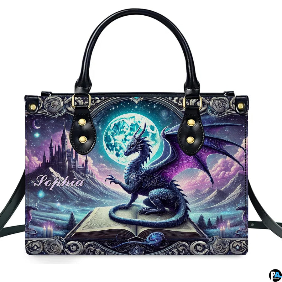 Structured fantasy dragon handbag displayed with shoulder strap on plain white background.
