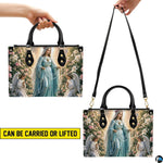 Side profile view of structured rosary handbag showing silhouette and black carry handles