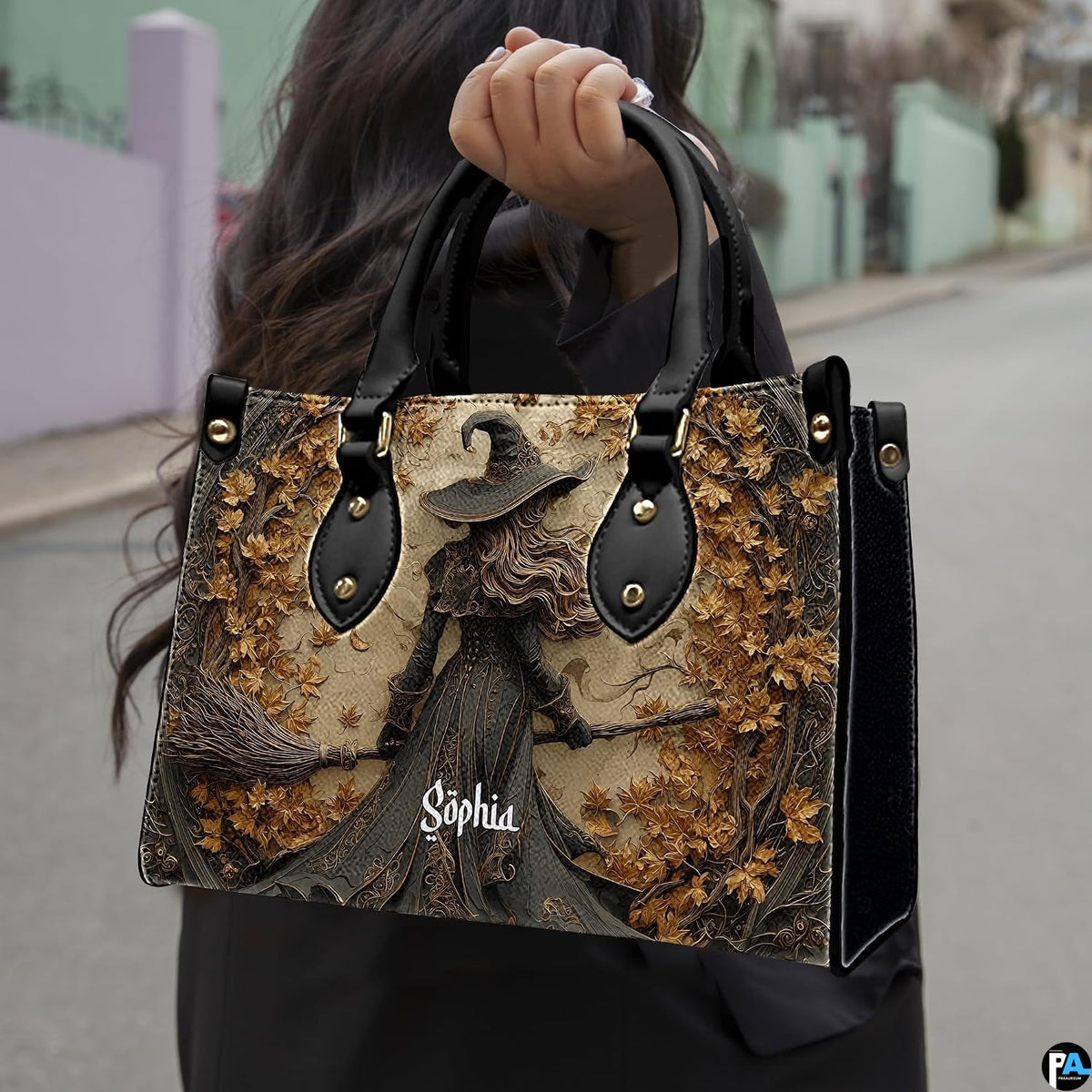 Gothic autumn witch handbag held by top handle while walking outdoors along a street.