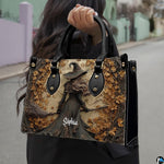 Gothic autumn witch handbag held by top handle while walking outdoors along a street.