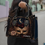 Frontal presentation highlighting the masquerade mask art design on the primary accessory silhouette.