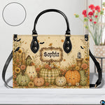Tabletop presentation of smiling pumpkin artwork positioned beside floral vase and circular texture inset.