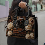 Side profile of black dragon handbag showing clean seams and dark library floral pattern