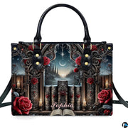 Isolated front view of gothic cathedral handbag showing stone window arch, grimoires, and crimson roses.