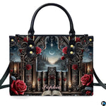 Isolated front view of gothic cathedral handbag showing stone window arch, grimoires, and crimson roses.