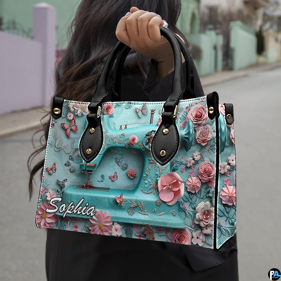 Model outdoors holding turquoise sewing machine artwork accessory in natural daylight.