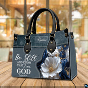 Close-up of sculpted white petals, navy blue blossoms, and golden botanical accents.