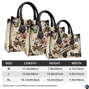 Angled perspective view of lily cross handbag highlighting floral depth and cross details.
