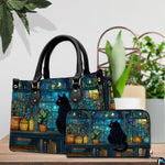 Tabletop scene presenting midnight stained glass cat artwork resting on wood beside green houseplants.