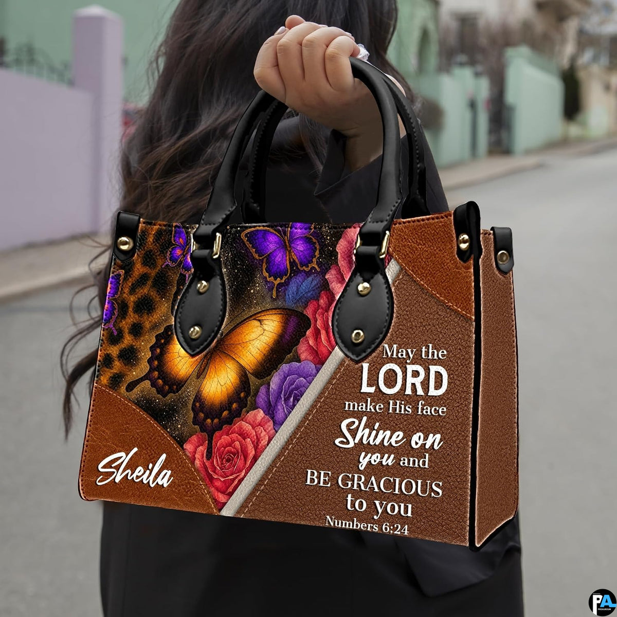 Side profile showing structured silhouette and brown textured finish of leopard floral handbag.