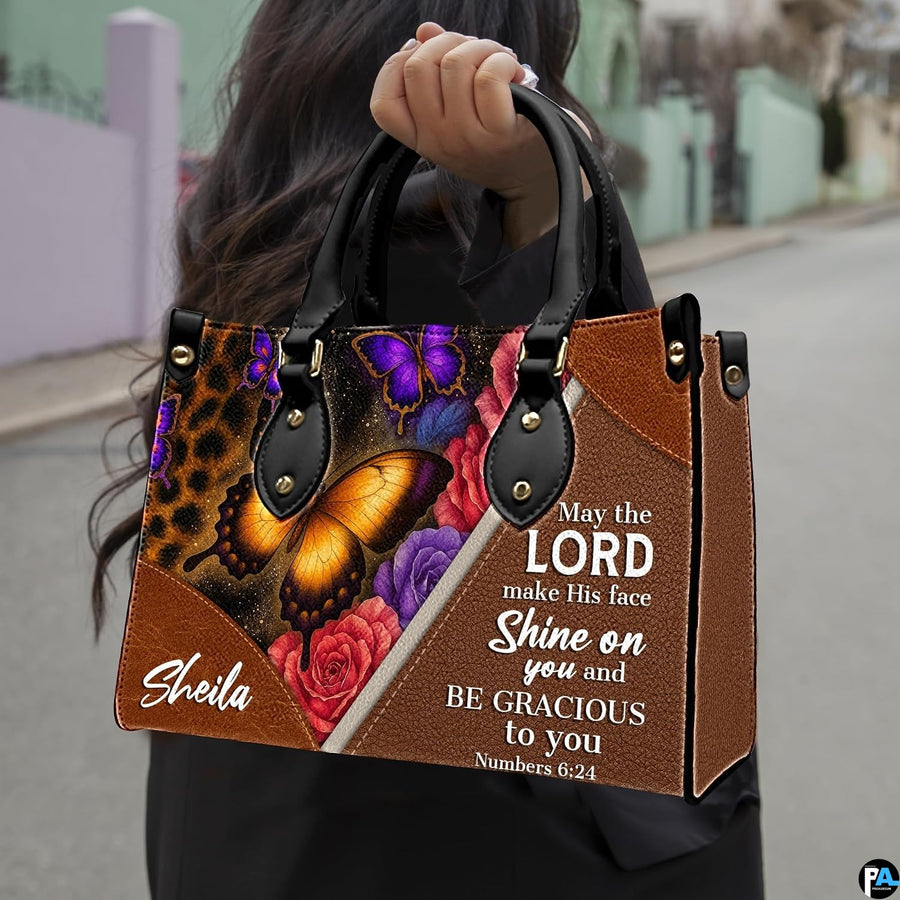 Side profile showing structured silhouette and brown textured finish of leopard floral handbag.