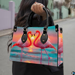 Outdoor lifestyle view of model carrying the flamingo heart sunset handbag.