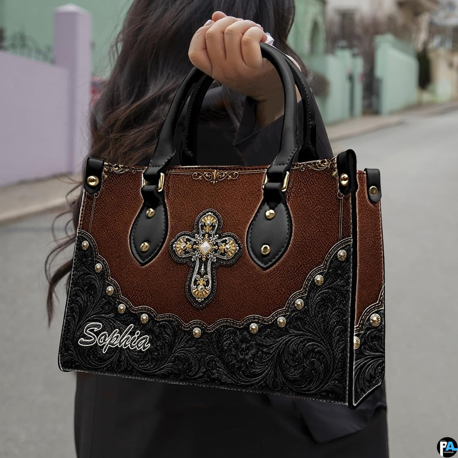Side profile showing structured silhouette and wrap-around floral corner tooling of handbag.