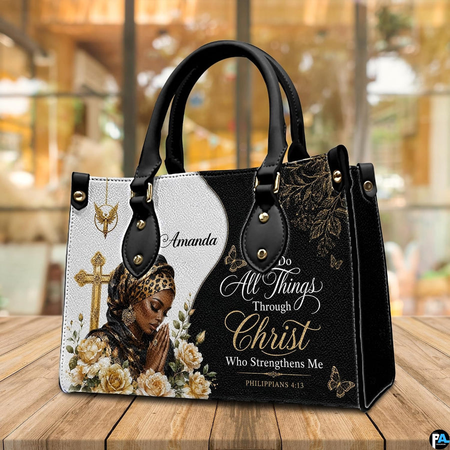 Angled perspective view of the praying woman Christian handbag resting on a wooden tabletop