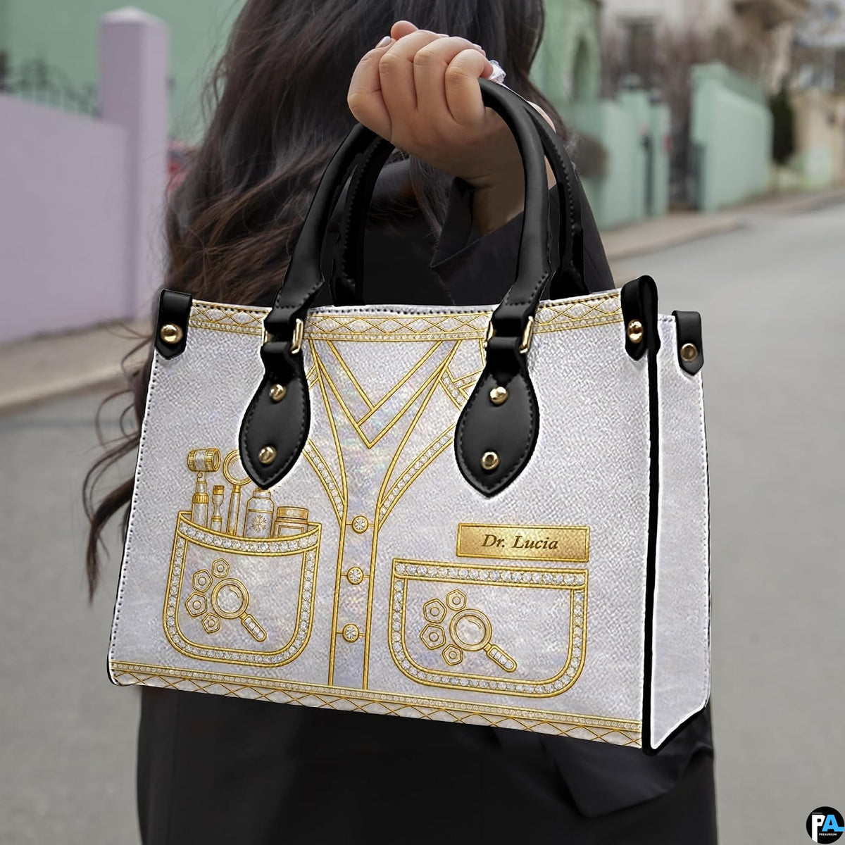 Angled view displaying the metallic gold dermatology uniform artwork printed across the handbag.
