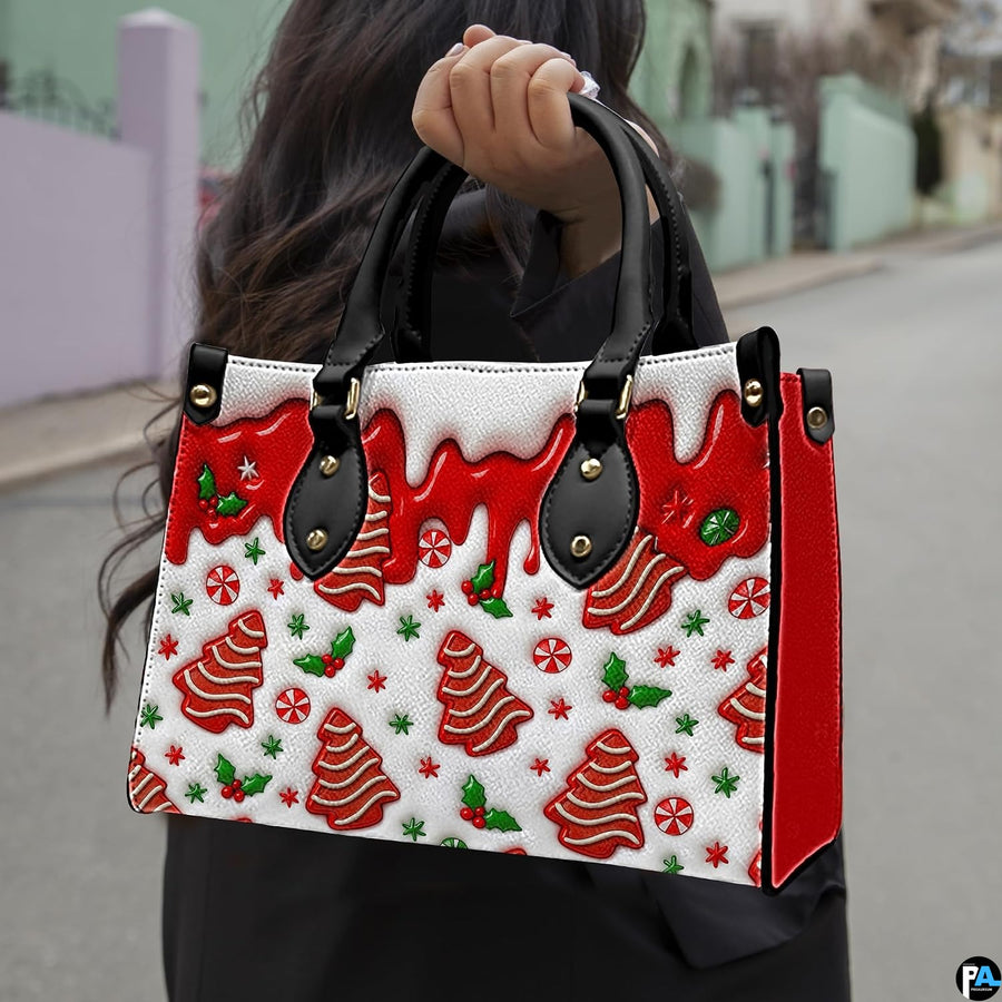 Outdoor lifestyle view of model holding gingerbread tree handbag displaying candy pattern and red side panel.