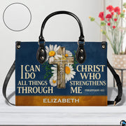 Front view of navy cross handbag on white tabletop with circular textured exterior swatch.