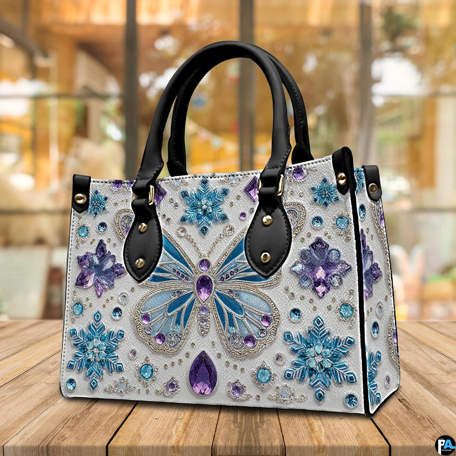 Top down view of butterfly handbag showing zipper closure and interior opening.