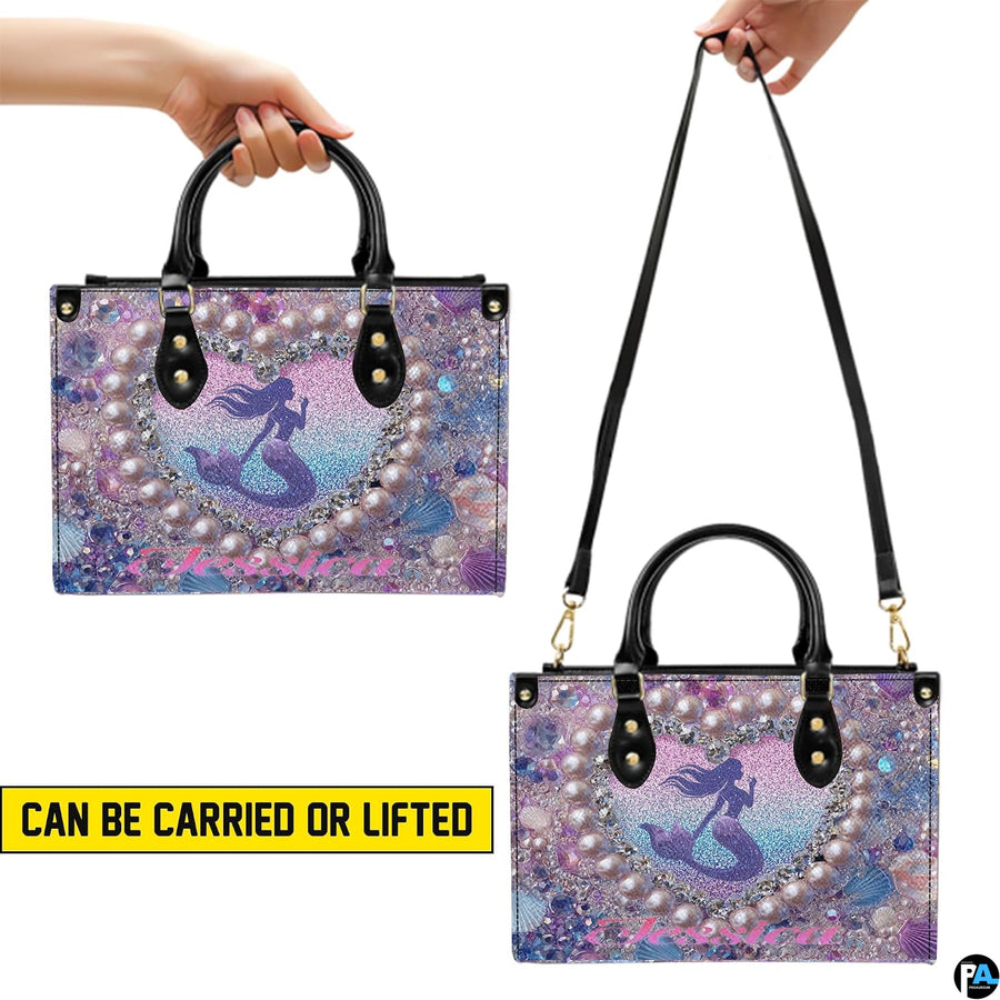 Matching mermaid wallet lying flat displaying the coordinating heart silhouette motif.