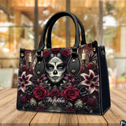 Dia de los Muertos handbag displayed on wooden tabletop in front of sunlit windows.