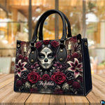 Dia de los Muertos handbag displayed on wooden tabletop in front of sunlit windows.