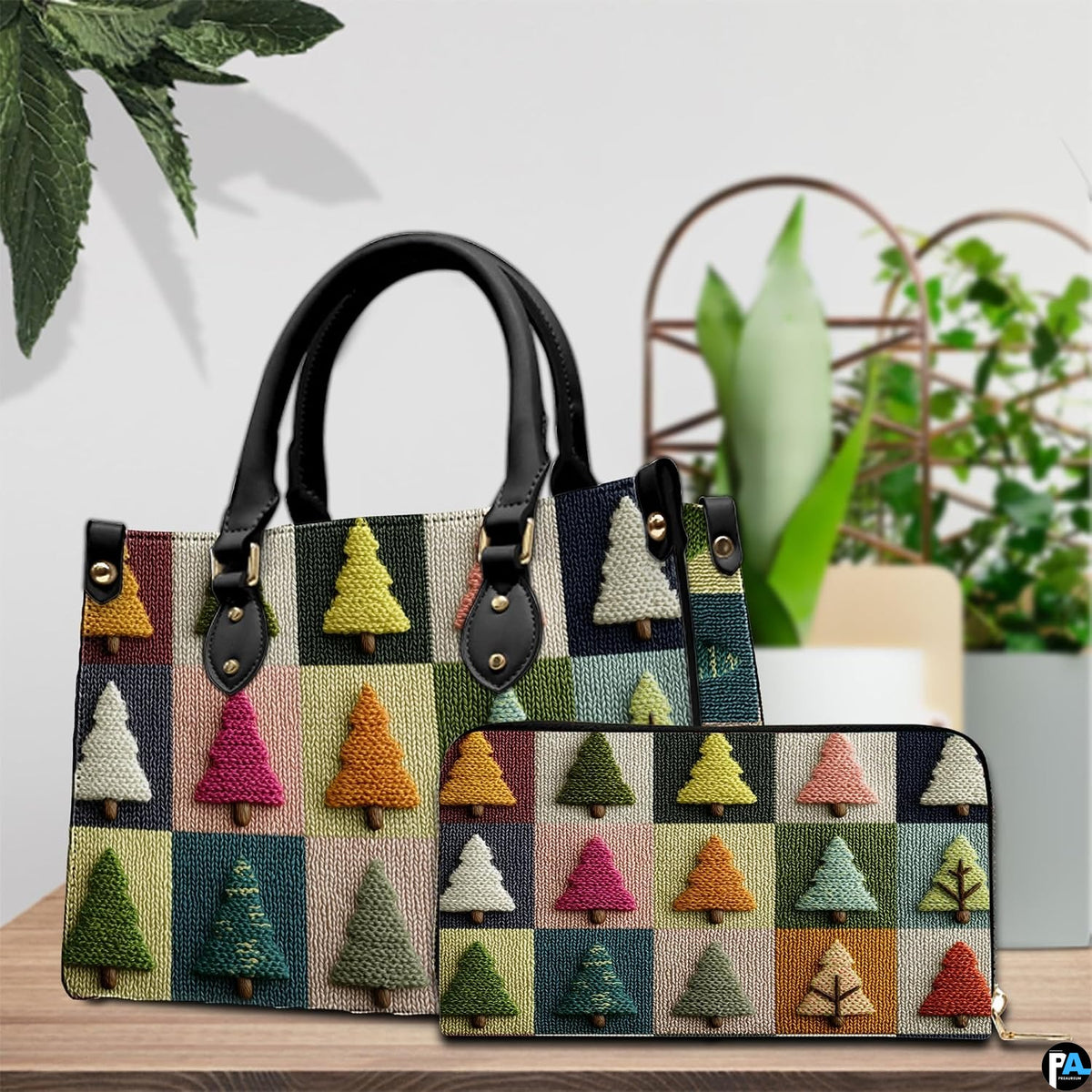 Tabletop presentation showing geometric pine tree grid artwork beside indoor houseplant.