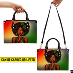 Afro portrait handbag shown with top handles and long strap