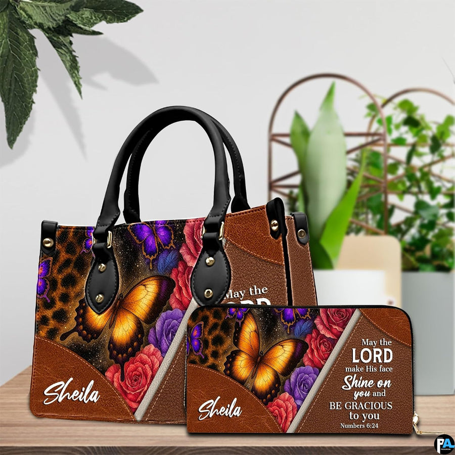 Detailed view of leopard rosettes, glowing amber butterfly wings, and blooming rose petals on handbag.