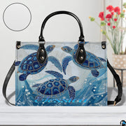 Angle perspective view of the sea turtle handbag highlighting coastal oceanic artwork.