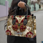 Perspective view of baroque ruby butterfly handbag and wallet pair
