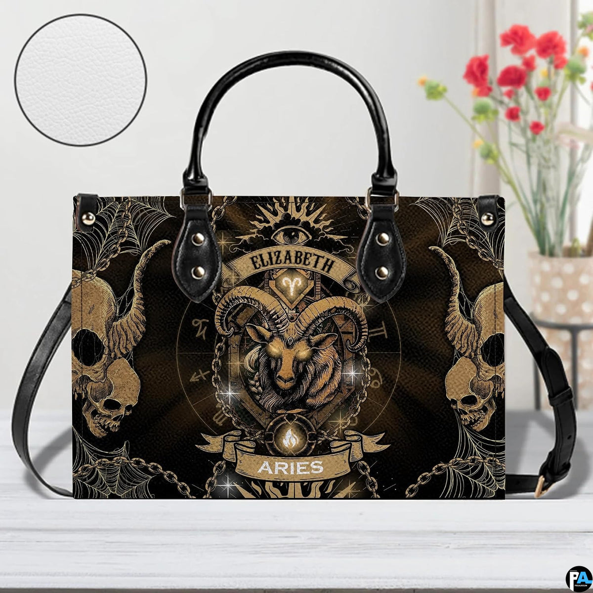Gothic Ram Zodiac Handbag resting on a white table beside floral arrangement with texture inset.