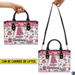 Front view showing black carrying handles, attachable shoulder strap, and pink confectionery drip illustration.
