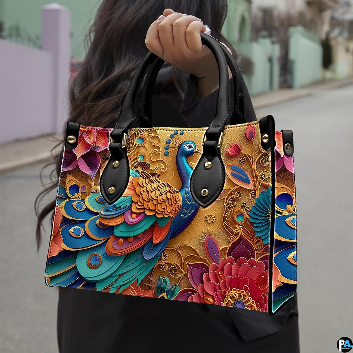 Woman carrying a colorful blue and gold peacock handbag