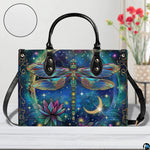 Bottom view of celestial dragonfly handbag showing protective metal feet studs and smooth base wrap