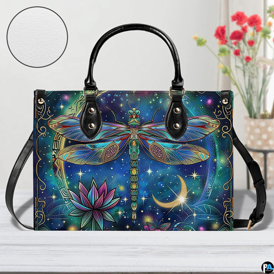 Bottom view of celestial dragonfly handbag showing protective metal feet studs and smooth base wrap