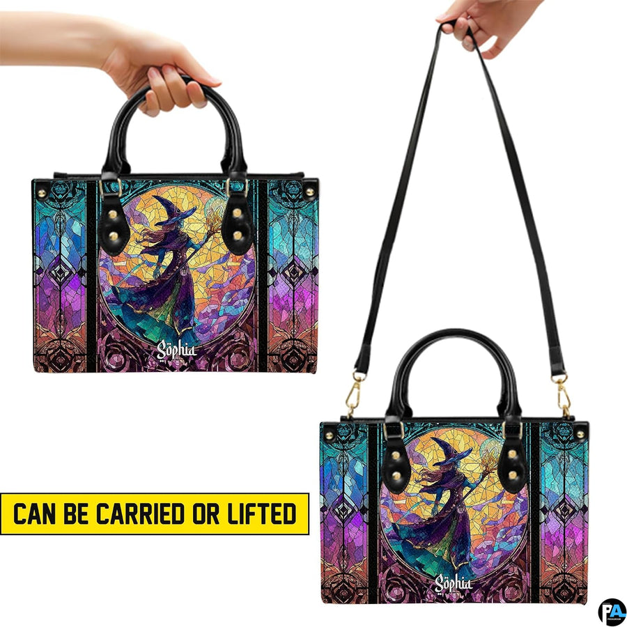 Stained glass witch handbag held by top handle while walking outdoors along a residential street.