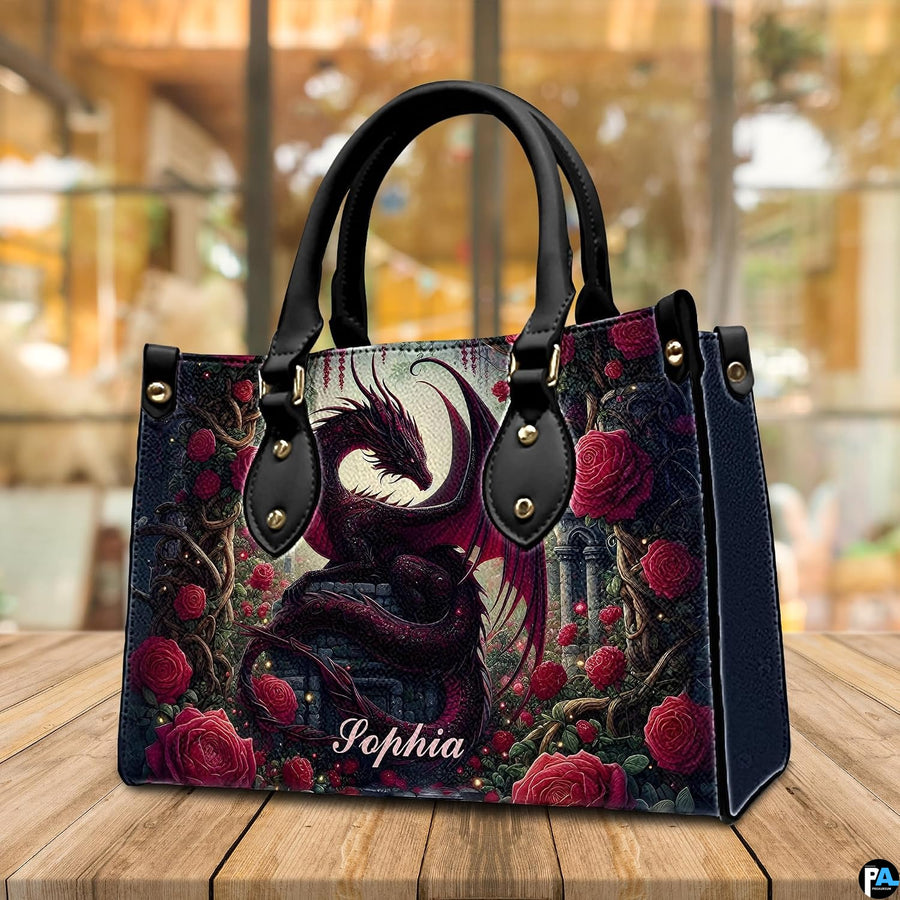 Crimson dragon handbag on wooden cafe table with warm background lighting.