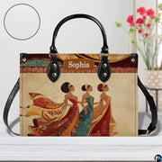 Tabletop perspective of the African queen handbag displayed with decorative blooms and texture swatch.