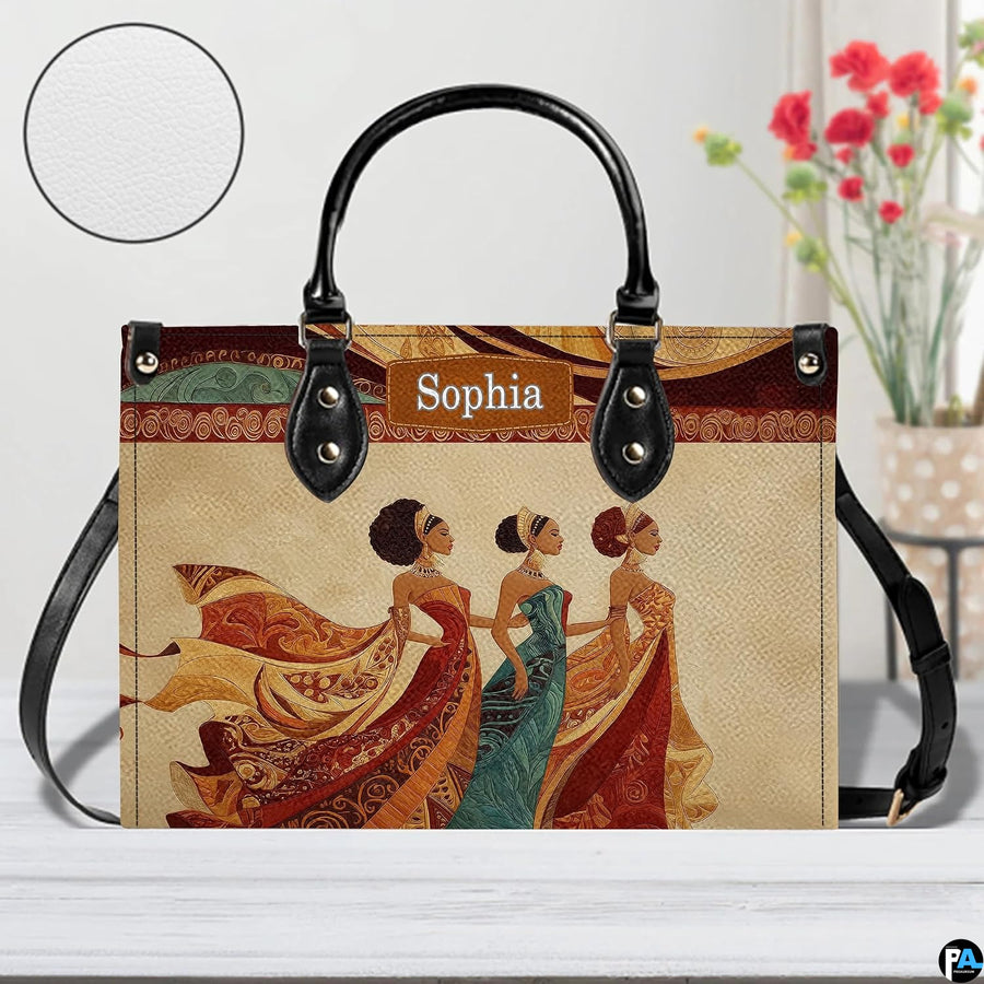 Tabletop perspective of the African queen handbag displayed with decorative blooms and texture swatch.