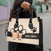 Close-up front view of curious cartoon tabby kittens on structured tote handbag