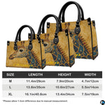Back view of ornate giraffe handbag showing continuous yellow damask pattern.