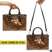 Top-down view displaying interior compartment and black carrying handles of the handbag.