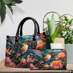 Handbag and matching wallet set displayed together on wooden table beside a green houseplant.