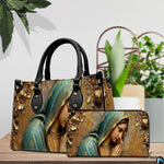 Angled perspective showing golden sculpted Mary bas-relief design on structured handbag