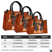 Zodiac afro queen handbag paired with matching wallet in rich cognac and retro sunset theme.