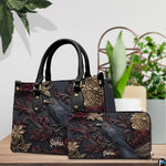 Gothic raven handbag displayed on wooden tabletop in front of sunlit windows.