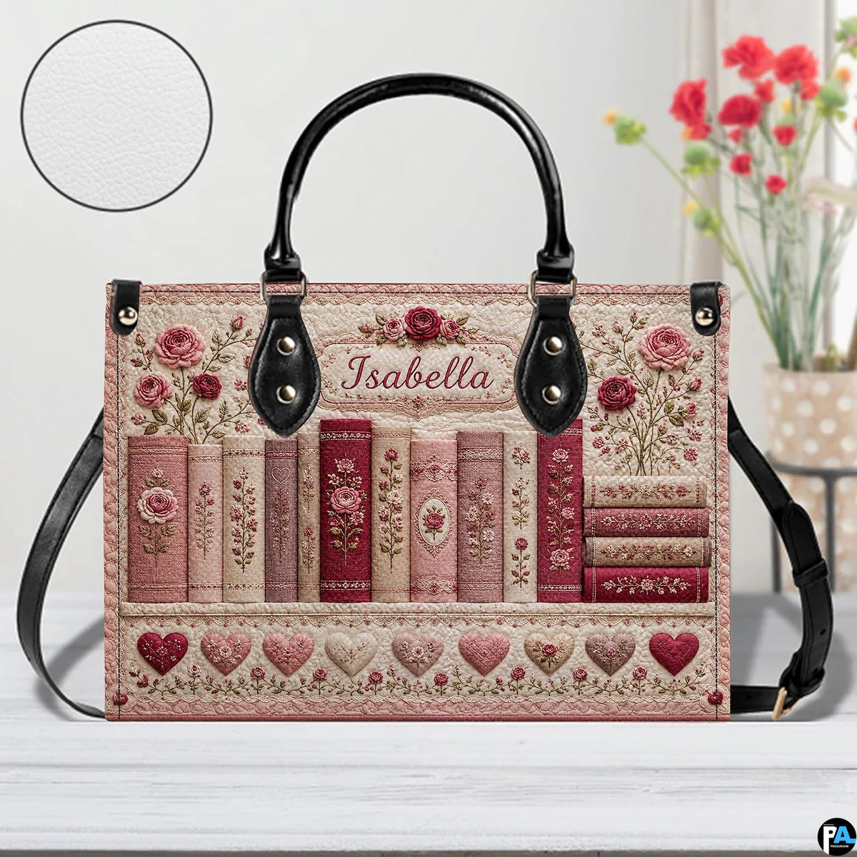 Close-up detail of textured rose embroidery on book spines and lower quilted heart border.