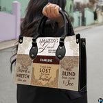 Angled view showing structured hymn typography patchwork handbag